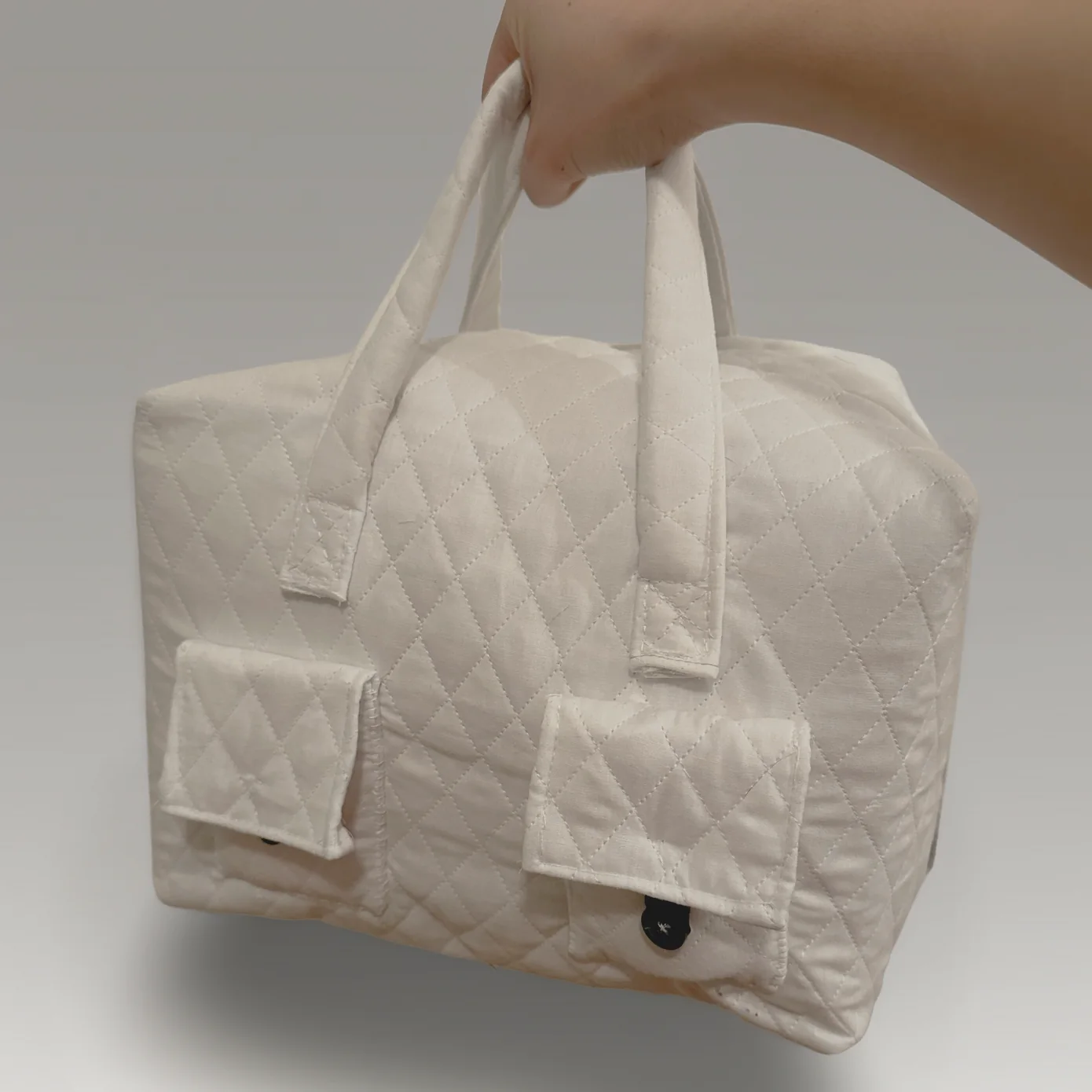 The organizing bag held up by its handles