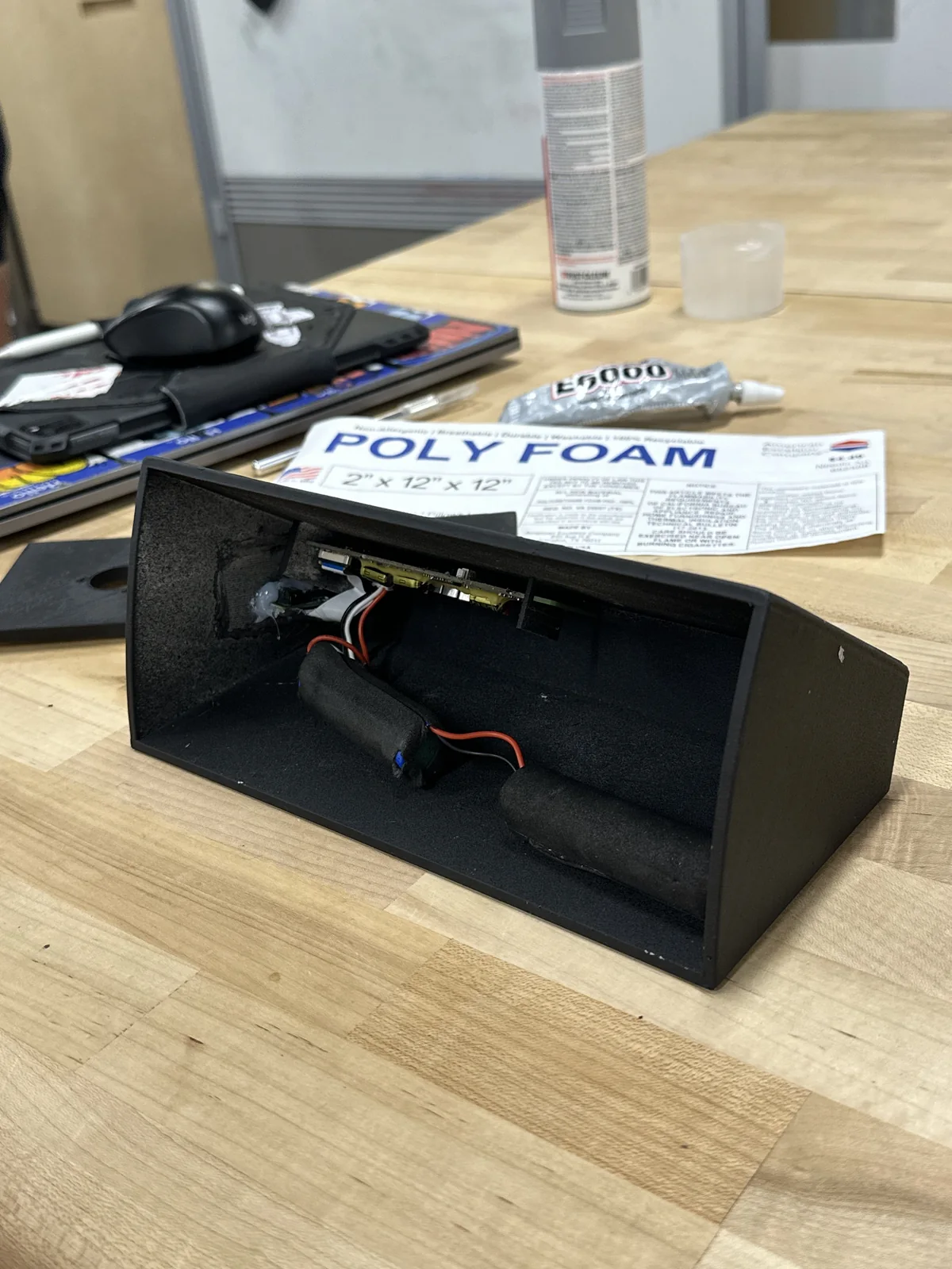 Open black printed housing with batteries and the circuit board fitted inside